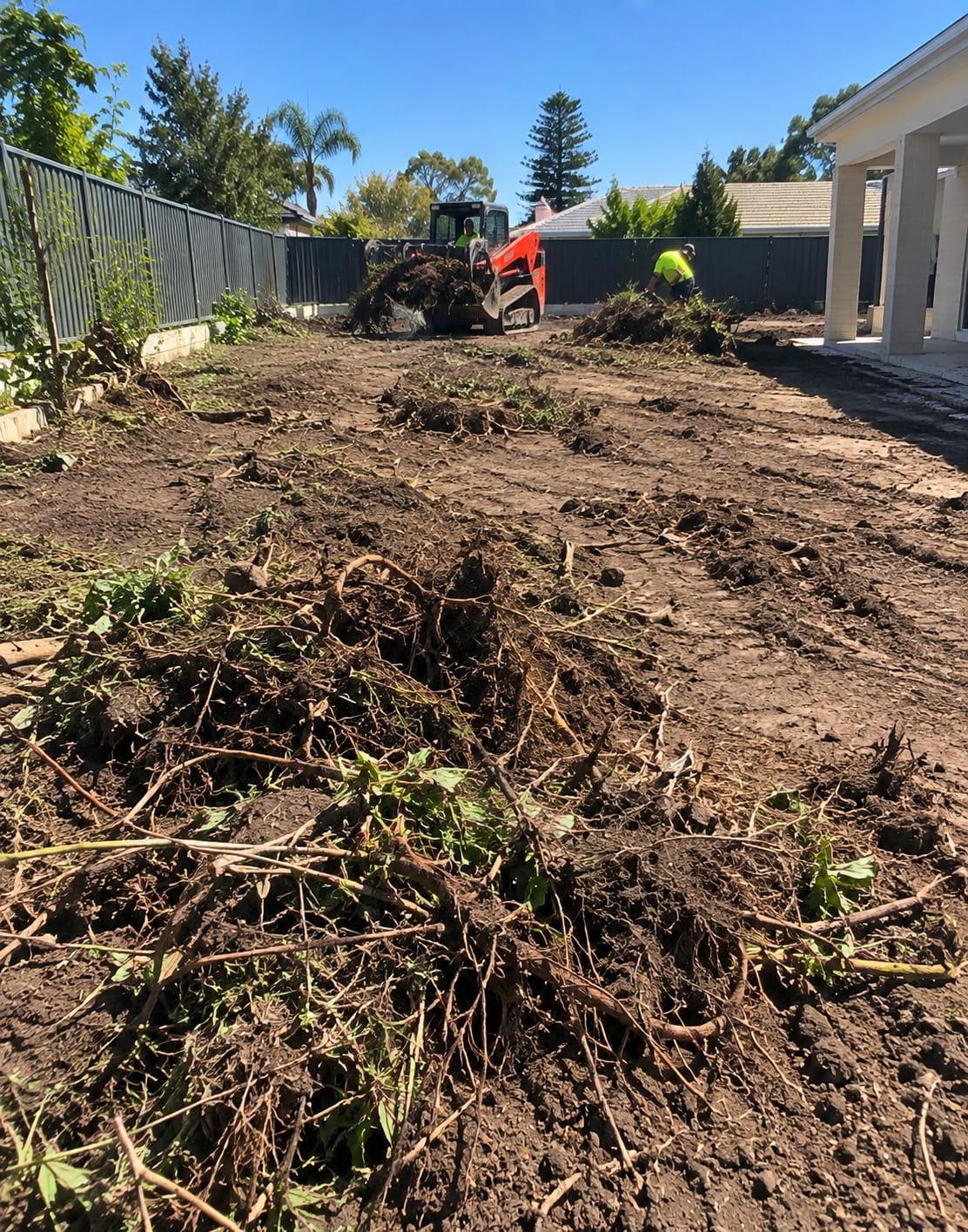 Weeds and roots being cleared from a Perth yard